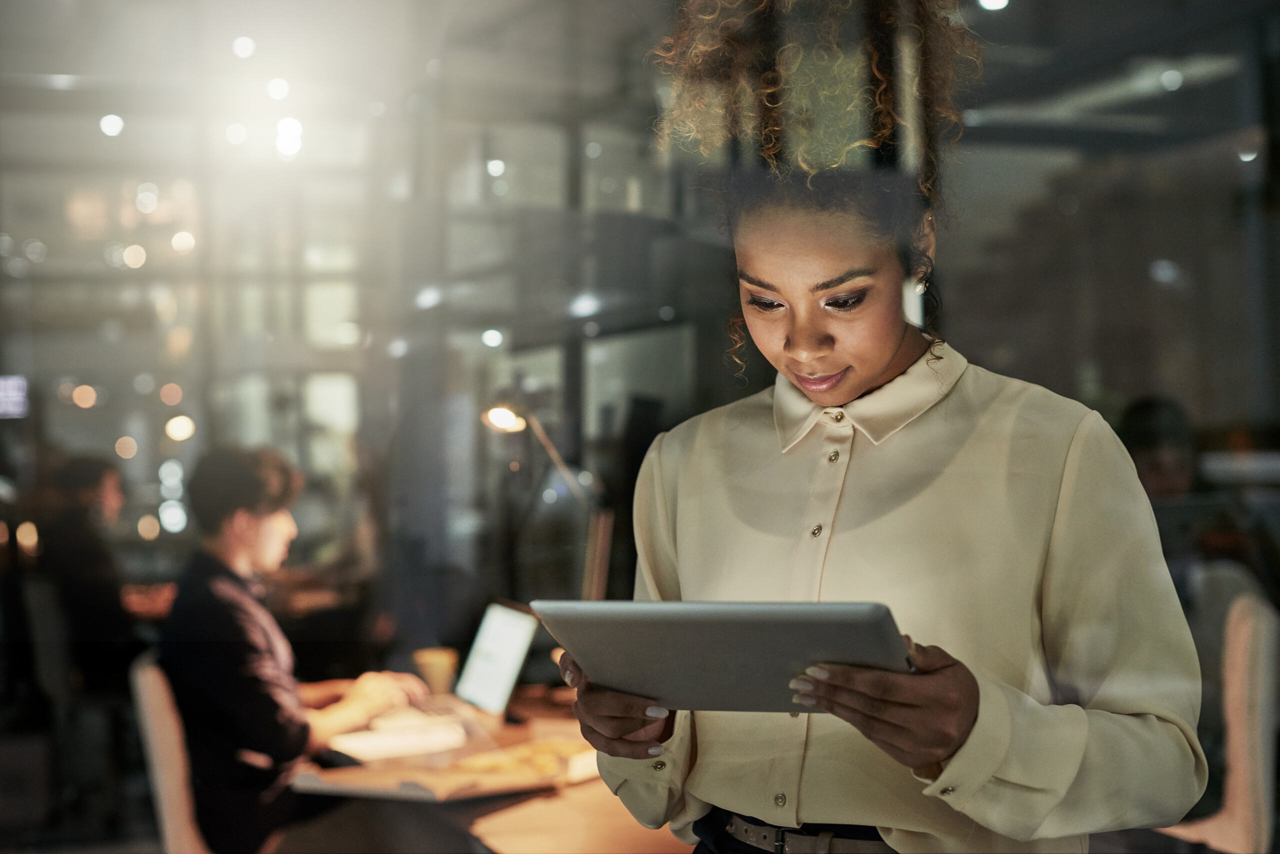 woman with headphones on listening to a virtual webinar