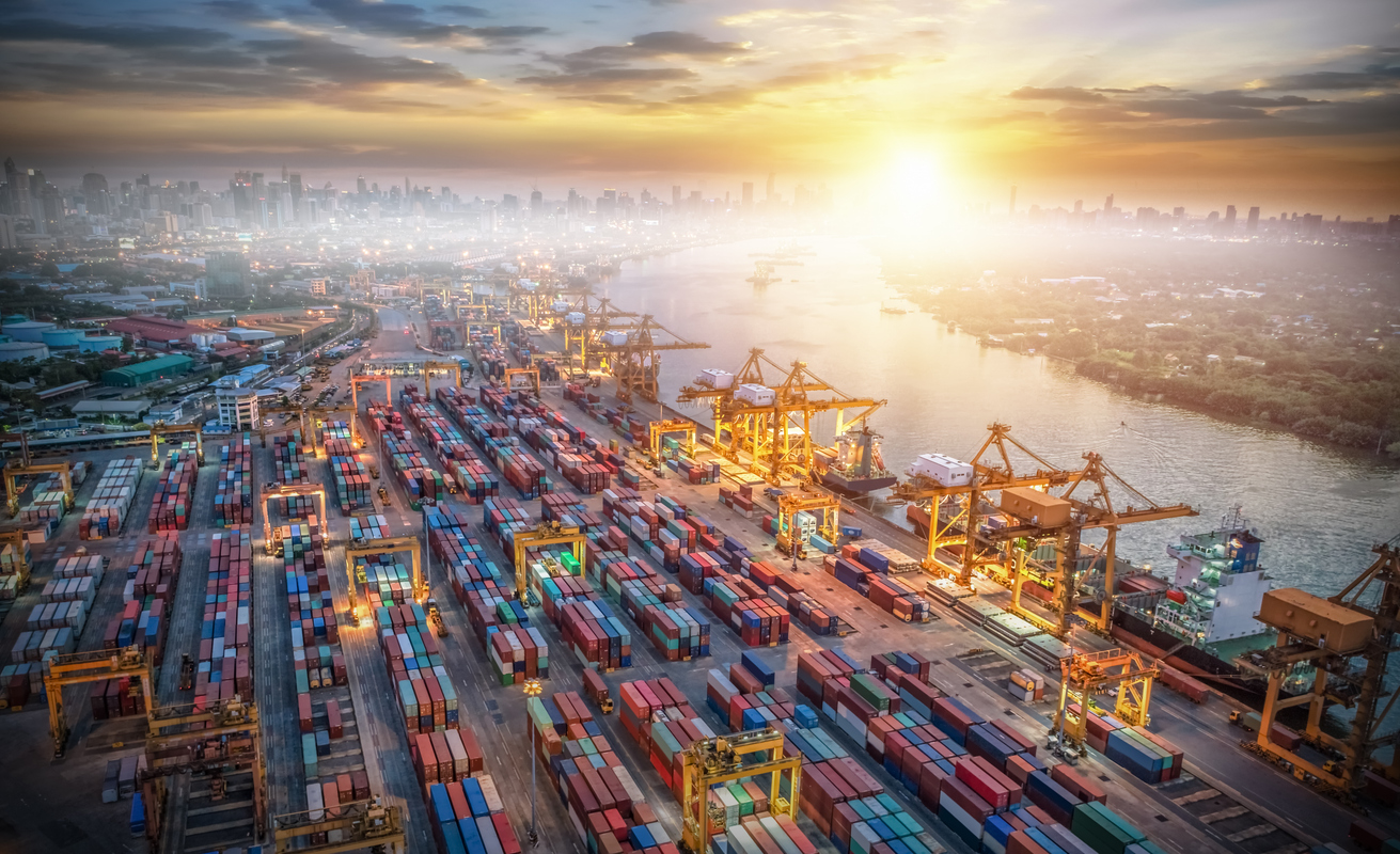 Freight manager with white hardhat looking at the camera with serious face expression
